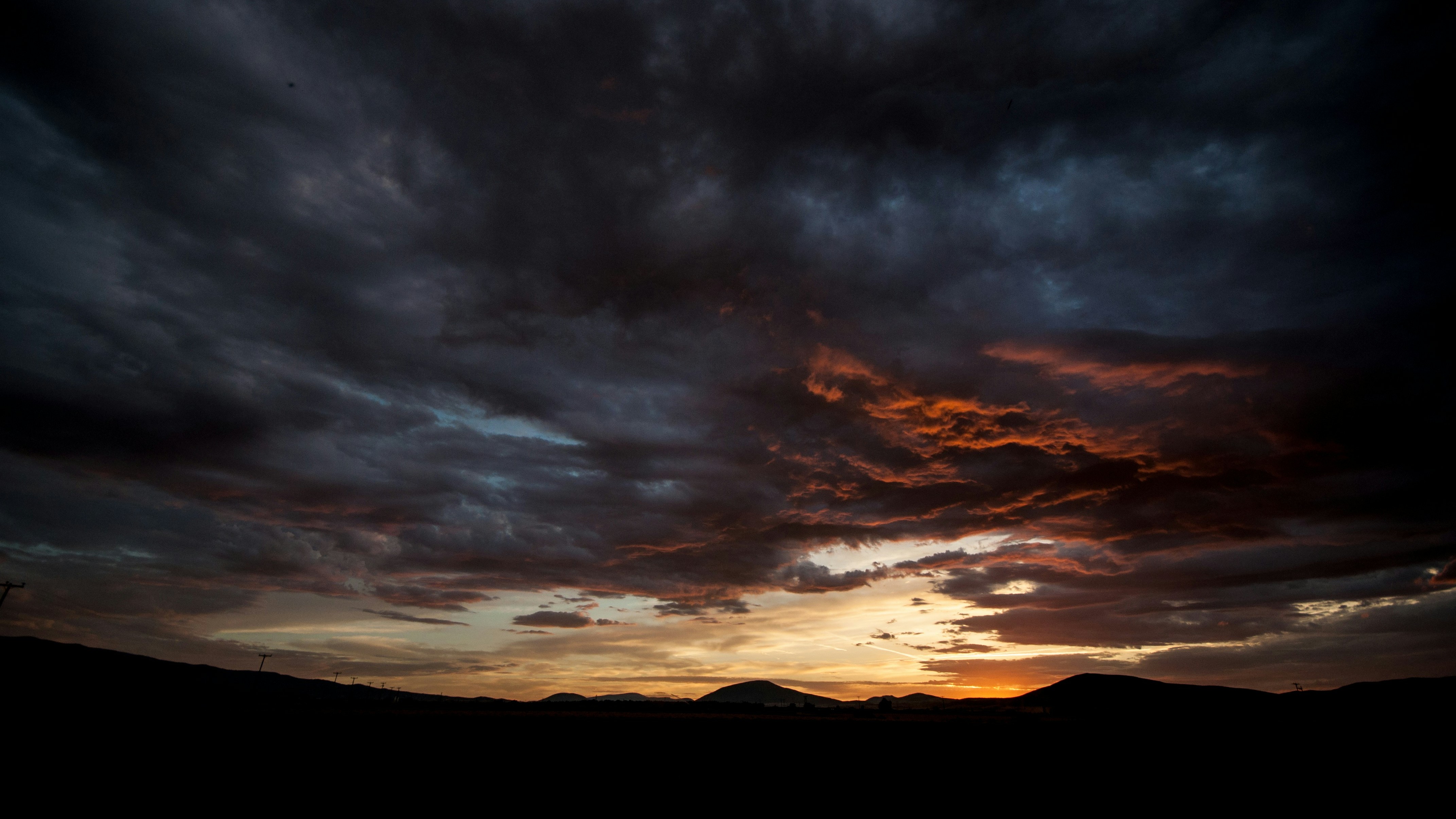 sunset over dark mountains