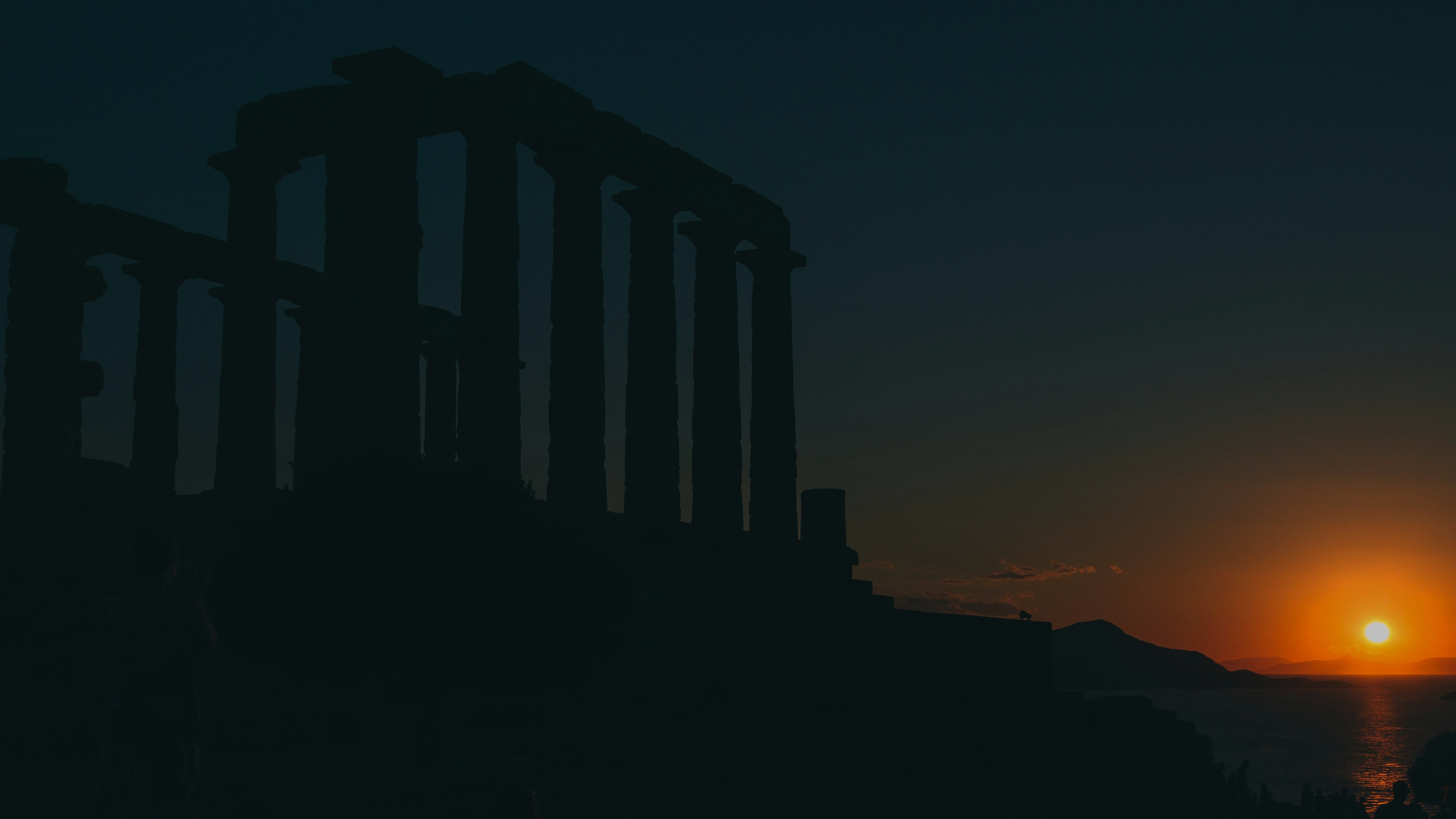 sunset behind silhouetted temple
