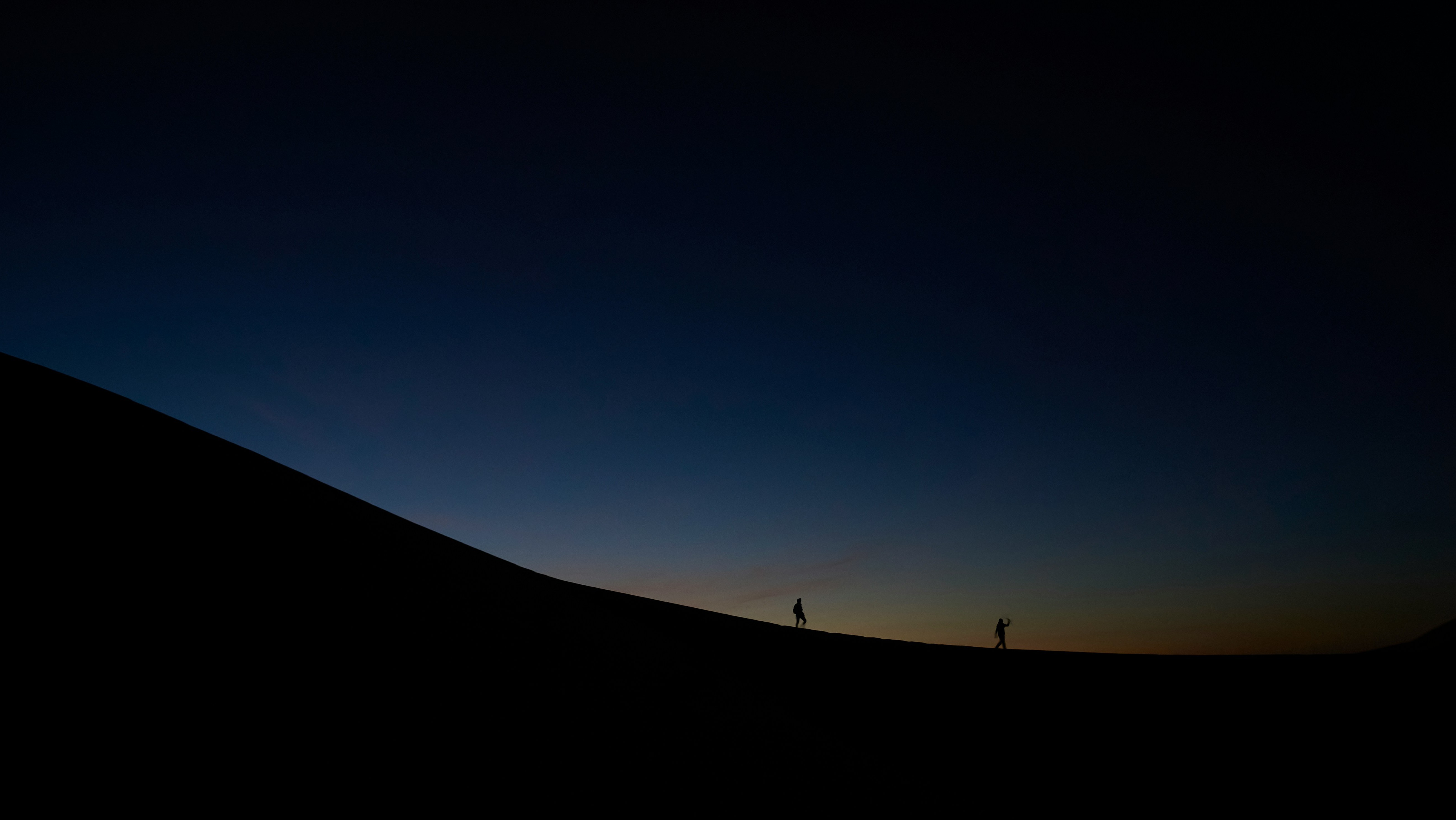 wanderers on desert hill at night
